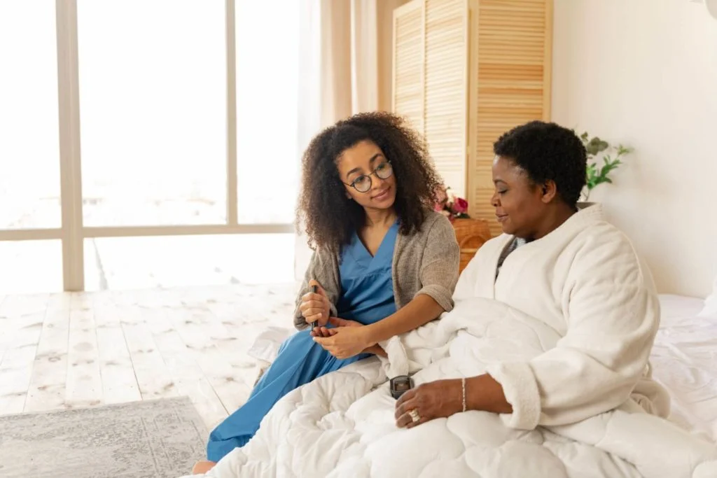 What is the First Home Care Visit Really Like? 3 Nurse wearing glasses taking blood test for woman with diabetes 1024x683 1